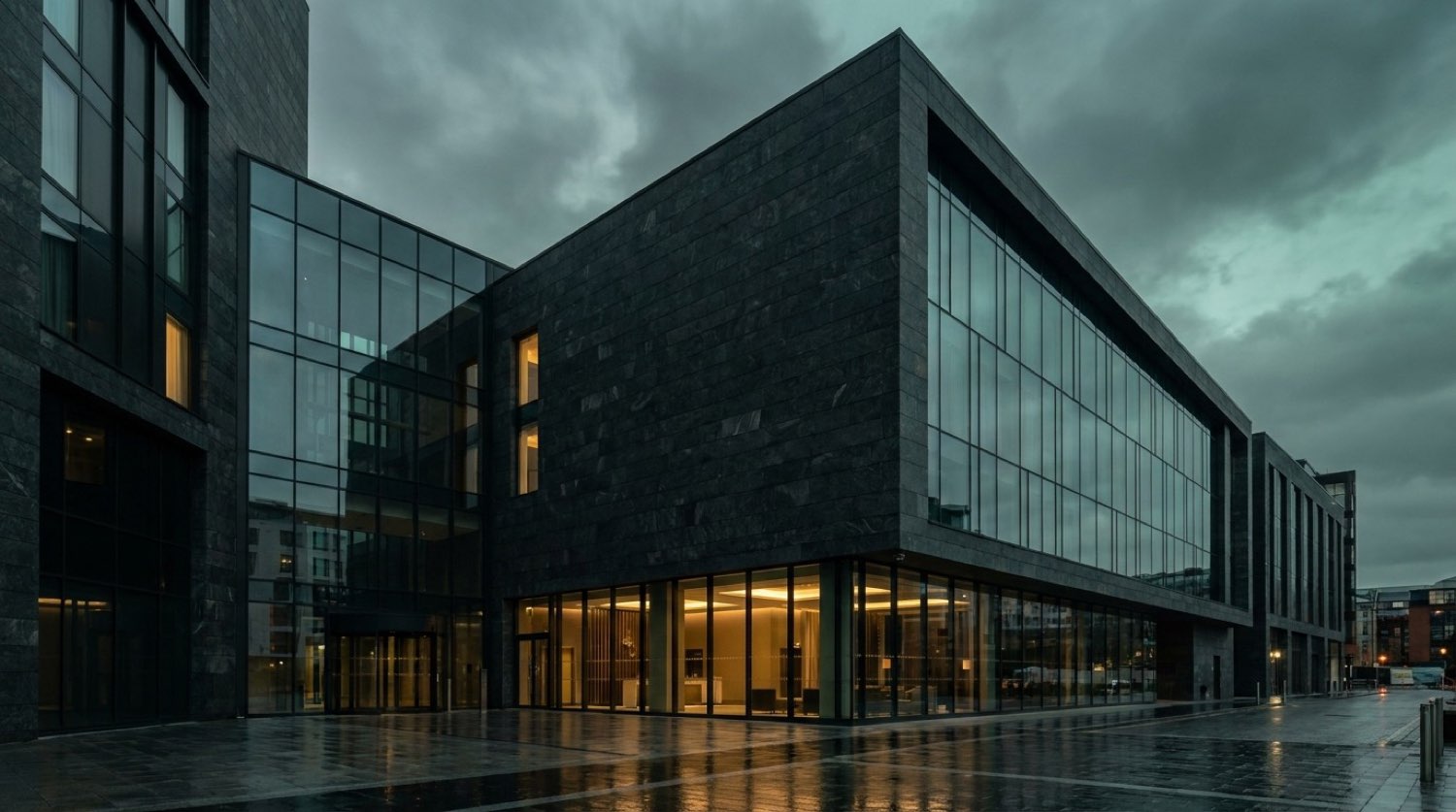 Sterling Crest exterior at dusk — dark glass facade, warm interior glow