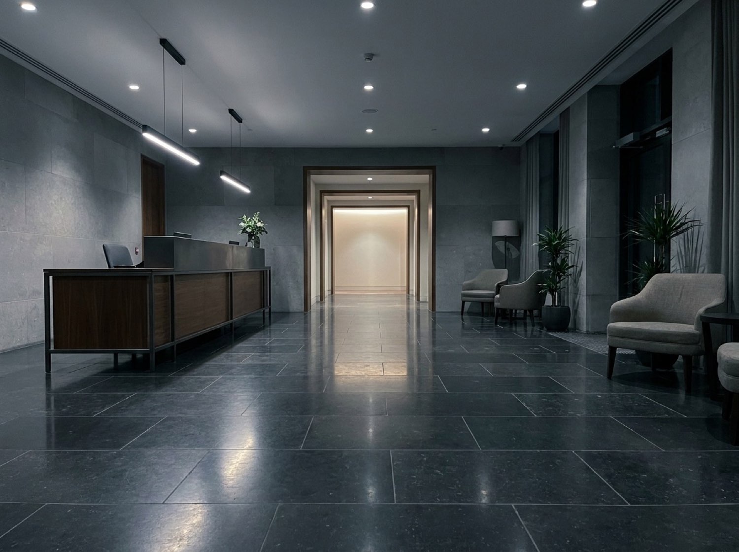 Sterling Crest lobby — dark stone floor, low reception desk, framed corridor